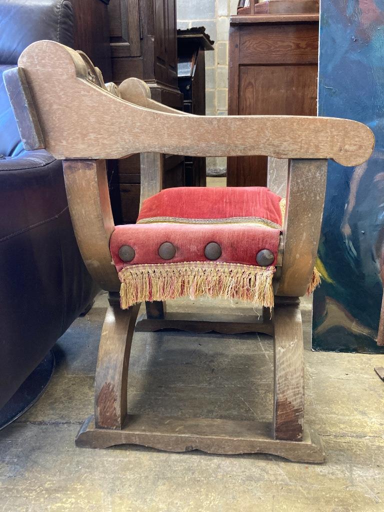 An 18th century style carved X frame oak chair, width 59cm, depth 49cm, height 77cm